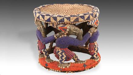 Social status is shown in this Bamileke stool, heavily decorated in glass beads and cowrie shells